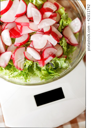 Dietary salad with radish and lettuce in a glass Dietary salad with radish and lettuce in a glass 42811742