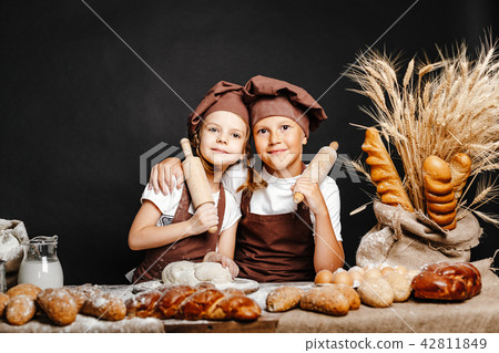 Adorable girl with brother cooking 42811849