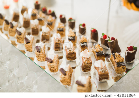 Delicious sweets on wedding candy buffet with desserts, cupcakes 42811864