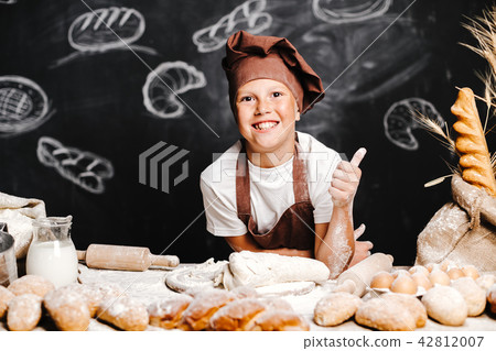 cute boy with chef hat cooking 42812007