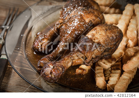 Fried chicken drumsticks with chips. Fried chicken drumsticks with chips. 42812164