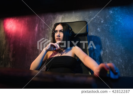 Girl gamer in headphones and with a computer mouse in her hand streaming playthrough or walkthrough Girl gamer in headphones and with a computer mouse in her hand streaming playthrough or walkthrough 42812287