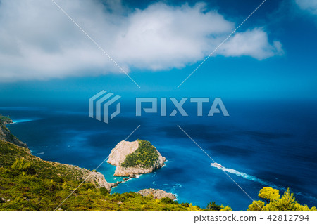 Zakynthos fantastic coastal view with white cliff. White tourist ship sailing full speed on open Zakynthos fantastic coastal view with white cliff. White tourist ship sailing full speed on open 42812794