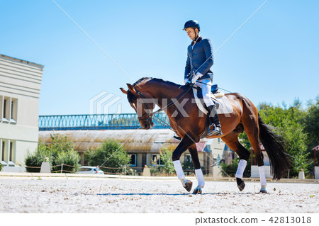 Horse man wearing helmet and riding boots looking very tired 42813018