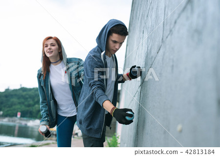 Nice creative man drawing graffiti Romantic date. 42813184