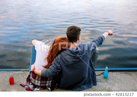Nice young woman putting her head on boyfriends shoulder Nice young woman putting her head on boyfriends shoulder 42813217