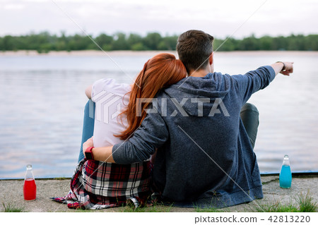 Nice young man showing a boat to his girlfriend Nice young man showing a boat to his girlfriend 42813220