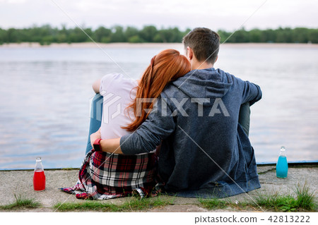 Nice peaceful couple looking at the river Nice peaceful couple looking at the river 42813222