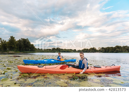 Loving couple enjoying beautiful landscape while rowing in canoe 42813573
