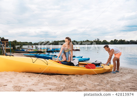 Cute loving couple getting ready for memorable river adventure 42813974