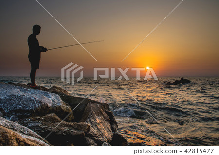 Man fishing on sunset Man fishing on sunset 42815477