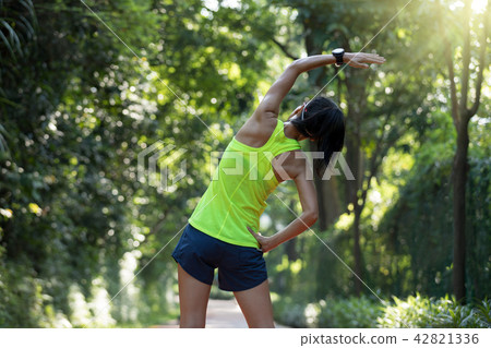 Healthy young woman stretching before run 42821336