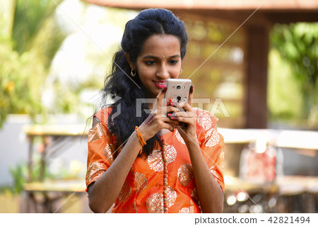 Young girl looking at her mobile, Pune Young girl looking at her mobile, Pune 42821494