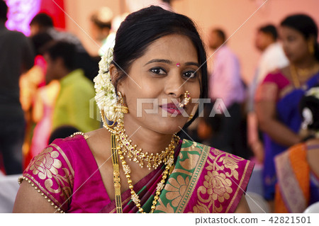 Woman dressed in Indian attire at wedding ceremony 42821501