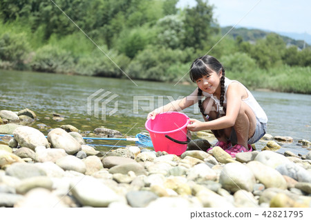 A girl showing a bucket inside 42821795