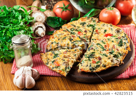 Frittata made of eggs, mushrooms and spinach Frittata made of eggs, mushrooms and spinach 42823515
