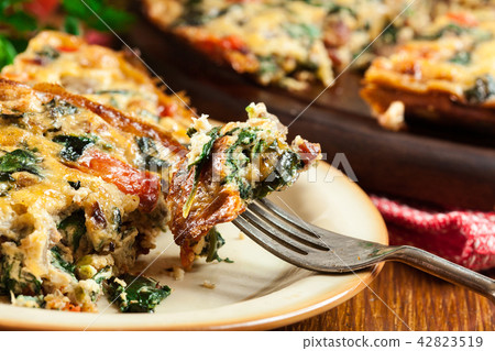 Portion of frittata made of eggs and mushrooms 42823519