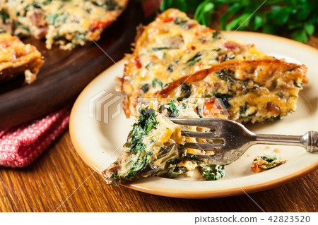 Portion of frittata made of eggs and mushrooms 42823520