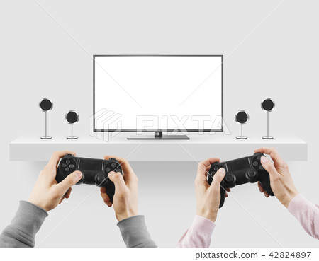 Man hold gamepad in hands in front of blank tv screen mock up pl 42824897