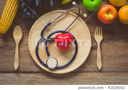 Healthy concept, fruit and ear doctor on wood 42826082