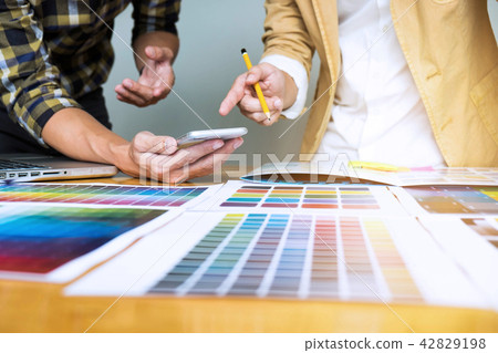 Graphic designers use smart phone choose colors. 42829198