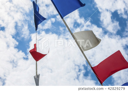 Colorful flags on blue sky and cloud 42829279