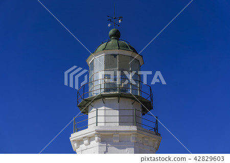 Deserted lighthouse against blue background. 42829603