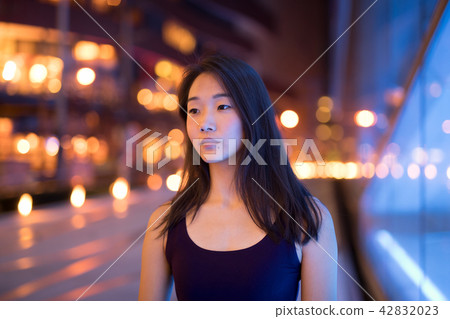 Portrait Of Beautiful Asian Woman Thinking Outdoors At Night Portrait Of Beautiful Asian Woman Thinking Outdoors At Night 42832023
