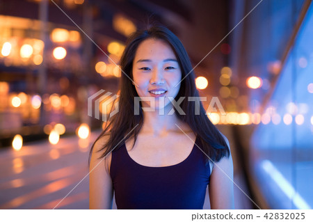 Portrait Of Beautiful Asian Woman Smiling Outdoors At Night Portrait Of Beautiful Asian Woman Smiling Outdoors At Night 42832025