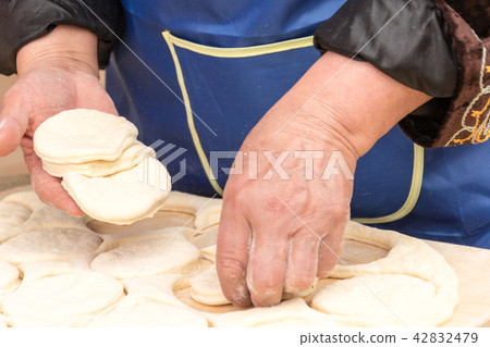 Woman prepares biscuits Woman prepares biscuits 42832479