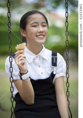 asian teenager eating icecream cone asian teenager eating icecream cone 42833965