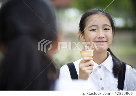 asian teenager eating icecream with happiness face asian teenager eating icecream with happiness face 42833966