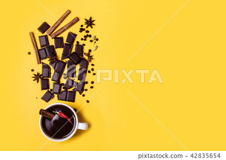 Hot chocolate cup with hot pepper and cinnamon.  42835654