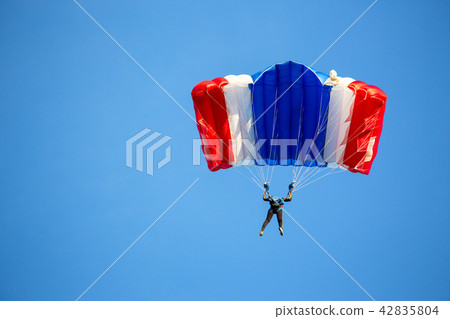 isolated skydiver in colorful parachute gliding isolated skydiver in colorful parachute gliding 42835804