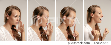 The young woman whispering a secret behind her hand The young woman whispering a secret behind her hand 42835836