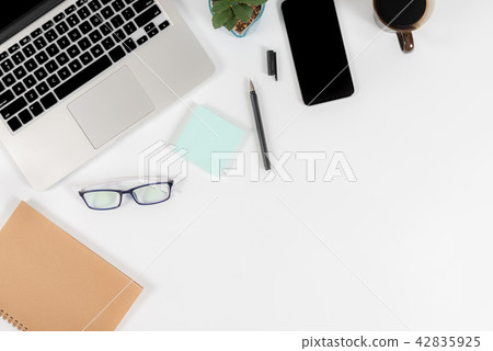 Office table with laptop computer and smartphone. Office table with laptop computer and smartphone. 42835925