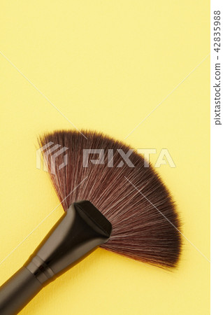 Make-up brush on the yellow background 42835988