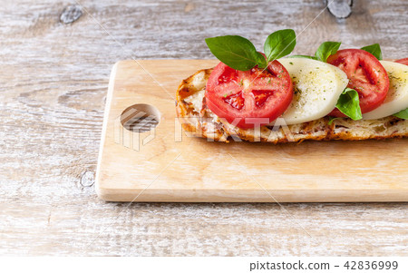 Sandwich with tomatoes, mozzarella, basil leaves Sandwich with tomatoes, mozzarella, basil leaves 42836999