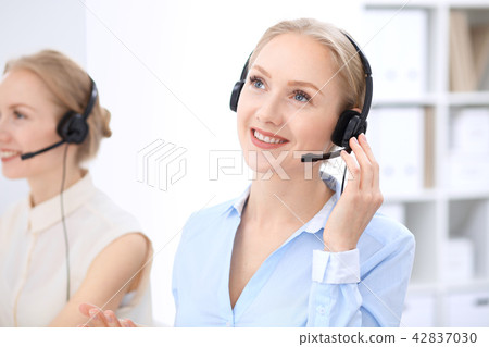 Bright call center office. Two blonde women in a headset Bright call center office. Two blonde women in a headset 42837030