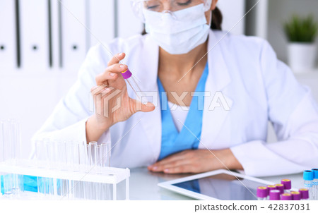Female scientific research is looking at the tube in laboratory. Blood test concept 42837031