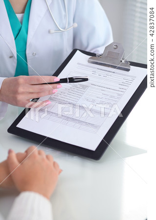 Doctor and patient, close-up of hands. Physician talking about medical examination results. Medicin Doctor and patient, close-up of hands. Physician talking about medical examination results. Medicin 42837084