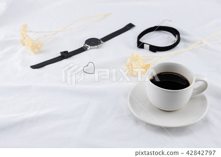 A cup of coffee with woman accessories 42842797