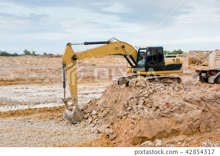 Yellow excavator machine working earth moving work Yellow excavator machine working earth moving work 42854317
