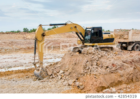 Yellow excavator machine working earth moving work Yellow excavator machine working earth moving work 42854319