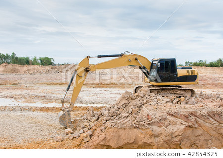 Yellow excavator machine working earth moving work 42854325