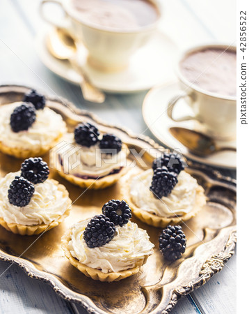 Mini tartlets with blackberries and coffee. 42856522