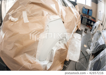 Garage painting car service. section of the car is covered with primer. vehicle is covered with 42857216