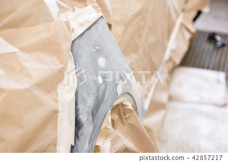 Garage painting car service. section of the car is covered with primer. vehicle is covered with 42857217