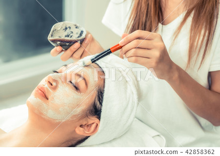 Beautiful woman having a facial treatment at spa. 42858362