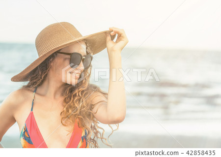 Happy young woman at beach in summer vacation. 42858435